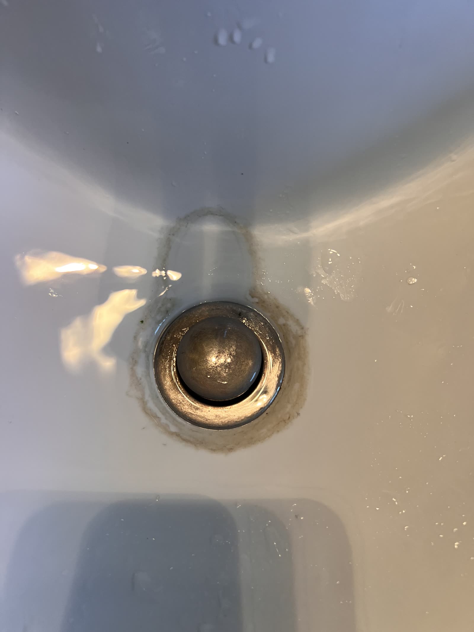 Before: Sink drain — mineral and grime buildup